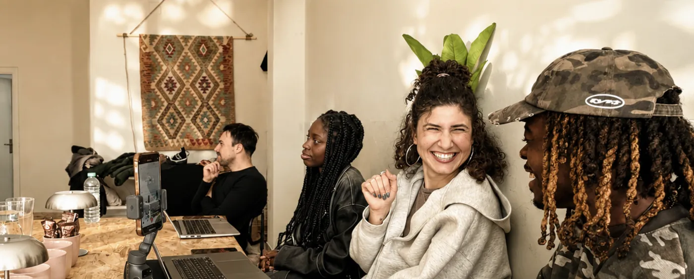 Members of the Out Of Office community laughing together
