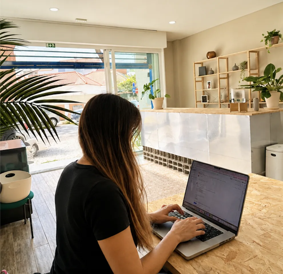 Person working on a laptop from behind